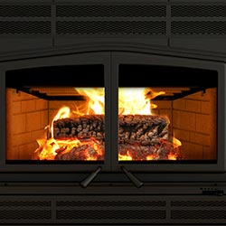 lifestyle image of wood burning in a wood fireplace insert