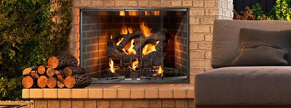 Cottagewood Outdoor Living outdoor Fireplace lifestyle during sunset burning a gas log set