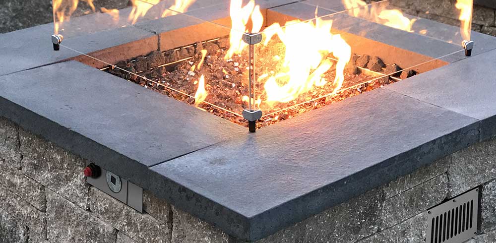Closeup of an ignited fire pit and control panel